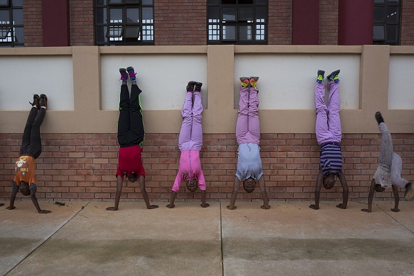 After the morning Buddhist service at the temple the children then start their fitness for the morning. This picture taken at 5:44am was preceded by the children running several laps around the grounds of the Swaziland branch of the Amitofo Care Centre who care for orphans and vulnerable children. The ability to do handstands stems from Kung Fu training, allowing the children to gain strength at an early age. The Swaziland centre opened in 2012 after four years of construction and is a joint venture between the Queen Mother's (who is also the matron) charity, Philani Maswati and Amitofo. CORNELL TUKIRI © 28 February 2017